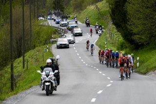 The pack in action during the fourth stage, a 151,7 km race between Saillon and Leysin at the 77th Tour de Romandie UCI World Tour Cycling race, in Le Sepey, Switzerland, Saturday, April 27, 2024. (KEYSTONE/Jean-Christophe Bott)